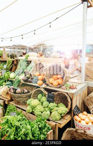 Gemüse und Obst auf Holzregalen werden auf dem Oranjezicht City Farm Market in Kapstadt, Südafrika, verkauft Stockfoto