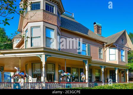 Das historische Bailey House, ist ein viktorianischer Queen Anne Stil mit einer Ausstellung von antiken Karussellpferden auf der Veranda, in Fernandina Beach, FL auf Amelia Stockfoto