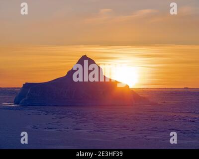 Sonnenuntergang am Ufer der gefrorenen Disko Bay. Disko Bay im Winter, Westgrönland. Amerika, Nordamerika, Grönland, Dänemark Stockfoto