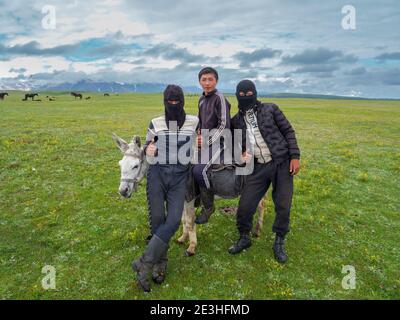 Junge Hirten auf ihrer Sommerweide. Die Gesichtsmaske schützt die Gesichter vor Kälte, Sonne und Staub. ALAJ Tal vor dem Trans-Alay Berg Stockfoto