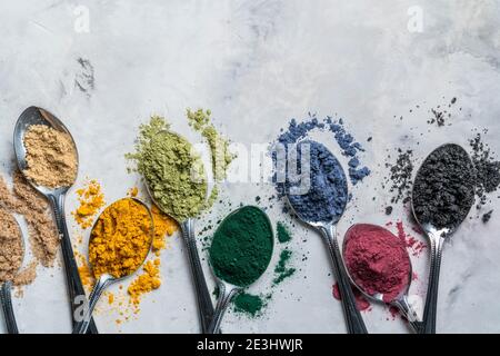 Super Pulver in Löffel - Matcha, Kurkuma, Ingwer, Kakao, Spirulina, Chia, Zimt, schwarzer Sesam Stockfoto