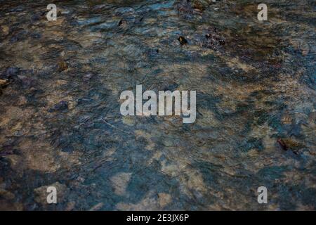 Muster von Felsen auf dem Bach Boden als Wasser fließt Vorbei Stockfoto