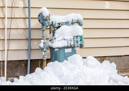 Erdgaszähler im Winter mit Schnee bedeckt. Konzept der Energieeinsparung, Heizkosten für Wohngebäude und Erdgasproduktion Stockfoto