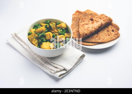 Aloo Mutter oder Matar aalu trocken Sabzi, Indische Kartoffel und grünen Erbsen gebraten zusammen mit Gewürzen und garniert mit Korianderblättern. Serviert mit Roti oder Stockfoto