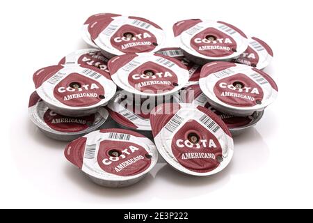 SWINDON, UK - 2. JANUAR 2021: Stapel von gebrauchten Costa Americano Kaffeepads auf weißem Hintergrund. Stockfoto