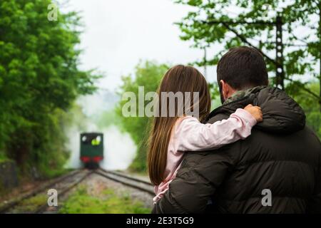 Ankunft der Dampfeisenbahn. Attraktion für Kinder und Eltern. Azpeitia, Spanien. Vater hält Tochter. Stockfoto