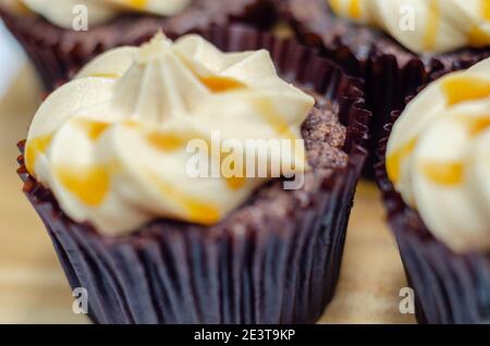 Gesalzene Karamell-Cupcakes, verführerische kleine Schokolade Cupcakes mit einem Baileys Geschmack Zuckerguss und Karamell Nieselregen, Süßigkeiten Stockfoto