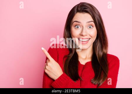 Foto-Porträt von erstaunt überrascht junge Mädchen lächelnd zeigt auf Leerer Raum mit Finger starrte isoliert auf rosa Hintergrund Stockfoto