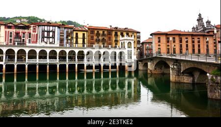 Tolosa Stadt. Bunte Gebäude, Markt und Brücke, Reflexion im Fluss. Baskenland, Spanien Stockfoto