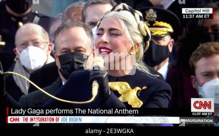 Eine CNN-Fernsehbildaufnahme der Sängerin Lady Gaga, die die Nationalhymne bei der Einweihung des US-Präsidenten Joe Biden am 20. Januar 2021 aufführt. Stockfoto