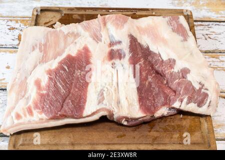 Zubereitung einer Porchetta mit einem Stück frischem Schweinefleisch Bauch in der Dicke geöffnet Stockfoto