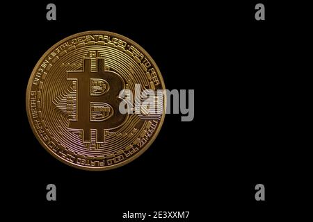 Einzelne wertvolle goldene Bitcoin auf dunkelschwarzem Hintergrund Vorderansicht Stockfoto