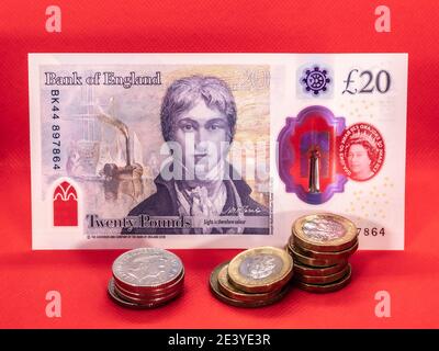 Eine neue £20 zwanzig Pfund-Note mit Sterling-Münzen. Diese neuen Polymer-Noten mit dem Künstler JMW Turner wurden 2020 in Großbritannien in Umlauf gebracht. Stockfoto