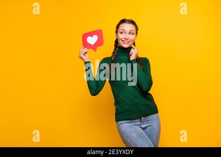 Portrait von schönen fröhlich neugierigen Mädchen halten in Händen Papier Kartenähnliches Denken isoliert auf hellgelben Hintergrund Stockfoto