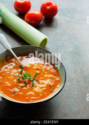 Schüssel Suppe aus gerösteten Tomaten und Löffel auf vintage Hintergrund. Speicherplatz kopieren. Stockfoto