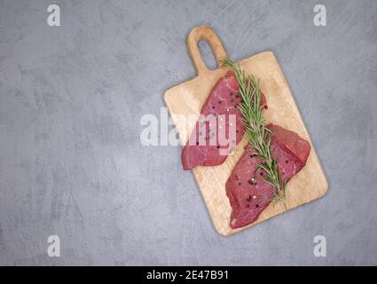 Frisches Rib Eye Steak auf Holz Schneidebrett. Rindersteak in Scheiben Stockfoto