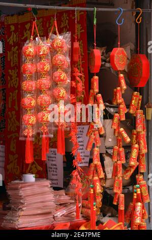 Rote Laternen und Feuerwerkskörper in einem Laden, der für die chinesischen Neujahrsfeiern bereit ist. Einmal im Jahr hat überall in China ein Meer von Rot. Stockfoto