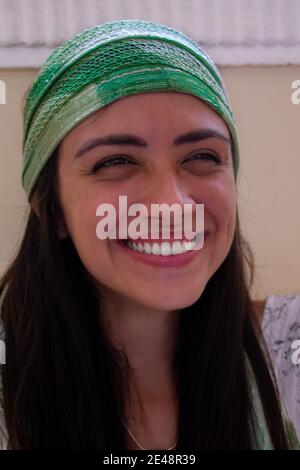 Porträt einer jungen fröhlichen und schönen Brünette Frau tragen Ein grüner Kopfbügel Stockfoto