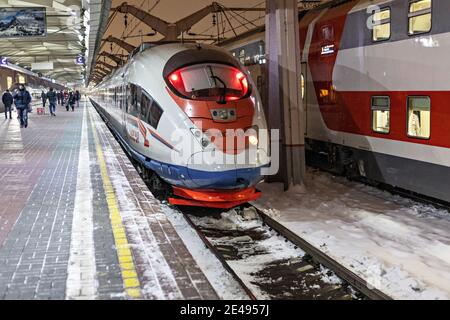 Ein Hochgeschwindigkeitszug steht auf dem Bahnsteig des Bahnhofs und wartet auf die Abfahrt. Winter. Stockfoto