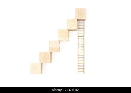 Treppe aus Spielzeug Holzblöcken und einer langen Holzleiter isoliert auf weißem Hintergrund. Konzept zur Karriereförderung. Stockfoto