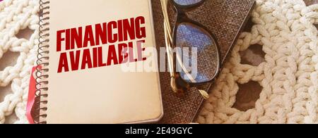 Finanzielle verfügbare Wörter auf dem Cover auf Notebook, Brille und Stift. Business-Konzept für Einkommen Geld Plan. Stockfoto