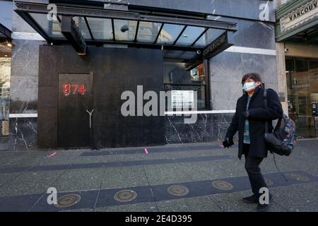 Vancouver, Kanada. Januar 2021. Ein Bewohner mit Gesichtsmaske geht an einem geschlossenen Geschäft in Vancouver, Kanada, vorbei, 22. Januar 2021. Quelle: Liang Sen/Xinhua/Alamy Live News Stockfoto