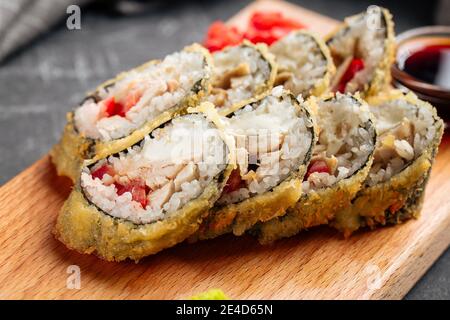 Nahaufnahme von gerösteten Tempura Sushi-Brötchen mit Huhn und Tomate Stockfoto