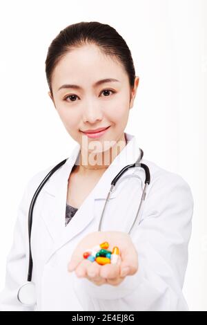 Die junge Ärztin hält eine Pille hochwertige Foto Stockfoto