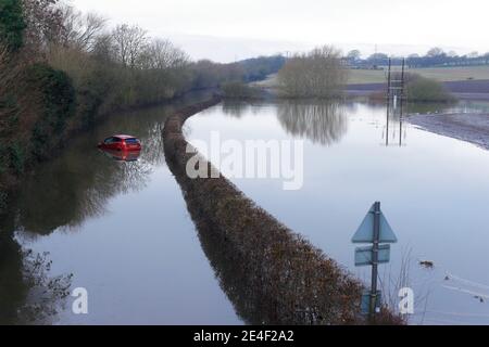 Ein Autofahrer musste sein Auto verlassen, nachdem er während des Sturms Christoph in der Newton Lane in Fairburn im Flutwasser gestrandet war. Stockfoto