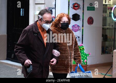 Ein Paar mit Gesichtsmasken geht an einem Happy Mask Shop vorbei, Barcelona, Spanien. Stockfoto