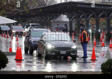 Autofahrer warten in der Schlange im Regen an einer Masse Super Point-of-Distribution Coronavirus COVID-19 Impfstelle am Cal State Northridge, Samstag, Jan. Stockfoto