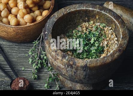 Kochen im mediterranen Stil: Kichererbsen und Gewürze auf einem Holztisch. Stockfoto