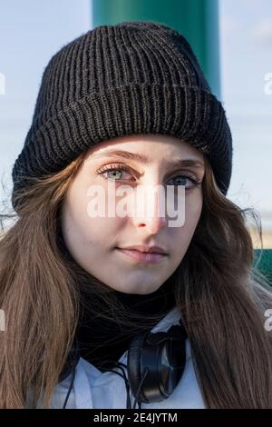 Teenager-Mädchen tragen Strickmütze starren, während im Freien stehen Stockfoto