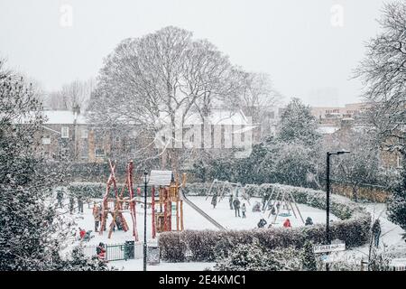 Camberwell, London, Großbritannien. Januar 2021. Kinder genießen den Schnee auf dem Spielplatz des Brunswick Park, Camberwell. Der erste Schnee in London seit Jahren bringt Kinder und Erwachsene in den Genuss einer Ruhepause von der UK Lockdown. Kredit: Tom Leighton/Alamy Live Nachrichten Stockfoto