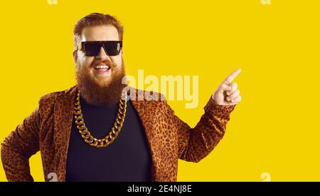 Lustige lächelnde rothaarige bärtige Mann Hipster in Leopard Jacke Zeigen zur Seite Stockfoto