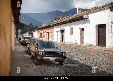 Ein Oldtimer steht auf einer gepflasterten Straße in Antigua, Guatemala, Mittelamerika Stockfoto