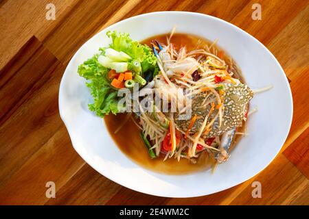 Thai Essen, Papaya Salat mit blauen Krabben auf einem weißen Teller, Papaya Salat mit Krabben Thai Essen. Stockfoto