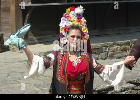 Etar, Bulgarien - 2. August 2011: Eine junge Braut tanzt mit einem Taschentuch neben dem Bräutigam; die Hochzeitszeremonie findet laut der Bulga statt Stockfoto