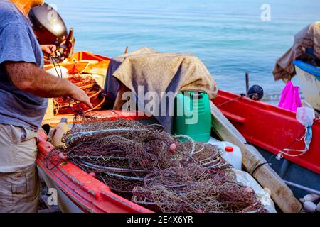 Fischer ist stapeln Fischernetz und bereiten sich auf seine nächste Angeln. Stockfoto