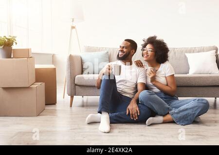 Schwarze Ehegatten Genießen Kaffee Sitzen Zwischen Boxen In New Home Stockfoto