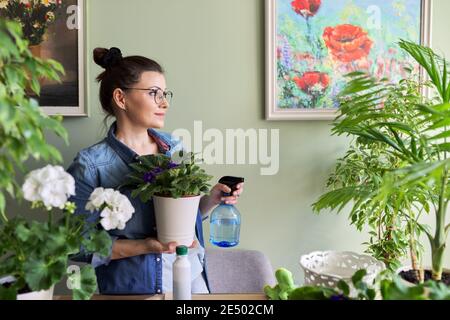 Frau kümmert sich um Zimmerpflanzen, Hobbys und Freizeit, Natur im Haus Stockfoto
