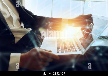 Businessman arbeitet auf dem Sofa mit seinem Laptop. Er ist im Smart Working Stockfoto