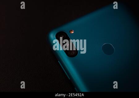 Selective focus on back of new smartphone Samsung Galaxy M11 triple camera and fingerprint sensor. Bucharest, Romania, 2021 Stockfoto