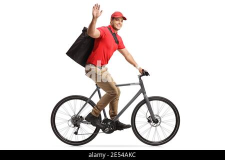 Mann mit Lebensmittelzustellung in einem roten T-Shirt, der Lebensmittel mit liefert Ein Fahrrad und Gruß mit Hand isoliert auf weißem Hintergrund Stockfoto