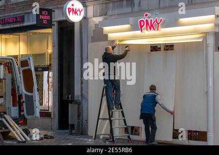 MAASTRICHT, NIEDERLANDE, JANUAR 26: Ladenbesitzer werden am 26. Januar 2021 in Maastricht die Fenster ihrer Geschäfte verbarrikadieren sehen, Niederlande, um mögliche Plünderungen zu vermeiden, da die Behörden die dritte Nacht in Folge auf Unruhen aufmerksam sind, nachdem die niederländische Regierung eine Ausgangssperre gesetzt hat, um die weitere Ausbreitung des Coronavirus zu stoppen. (Foto von Frank Kerbusch/BSR Agency/Alamy Live News) Stockfoto