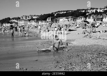 Mann, der sich mit Shisha am Strand entspannt. Trouville-sur-Mer, Normandie, Frankreich. Schwarz weiß historisches Foto. Stockfoto