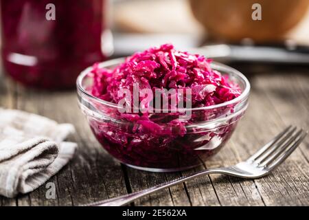 Rotes Sauerkraut. Sauer eingelegter Kohl in Schüssel auf Holztisch. Stockfoto
