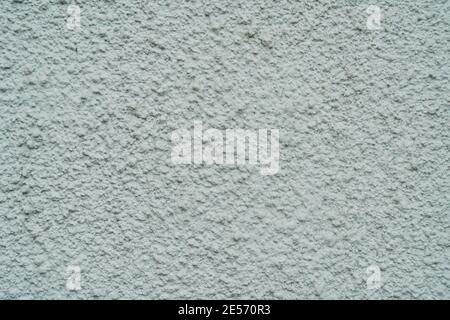 Hell verputzte Wand mit Defekten Textur aus der Nähe Stockfoto