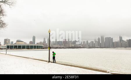 Chicago, USA. Januar 2021. Am 26. Januar 2021 wird ein Mann im Schnee in der Nähe des Shedd Aquarium in Chicago, Illinois, USA, gesehen. Ab Montagabend kam es in Chicago zu einem Wintersturm. Bis 9 Uhr Ortszeit Dienstag, waren die Schneesummen in einigen Teilen der Chicago-Gegend nahe an 8 Zoll gekommen. Quelle: Joel Lerner/Xinhua/Alamy Live News Stockfoto