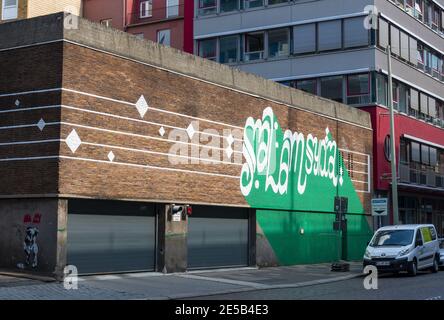 Graffiti gesprüht neben dem Eingang zur Tiefgarage hinter dem modernen Bürogebäude in Hamburg, Deutschland Stockfoto